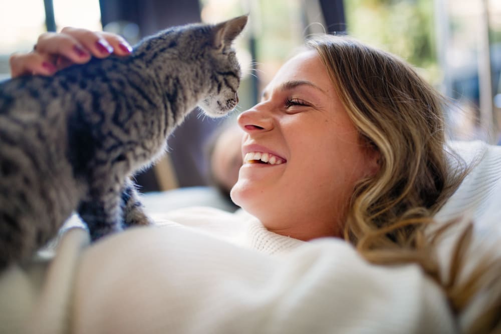 Resident snuggling their cat in bed at Oakshade Commons in Davis, California