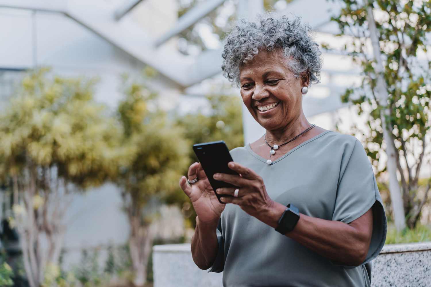 Resident using online portal with her mobile at Minuet in Las Vegas, Nevada