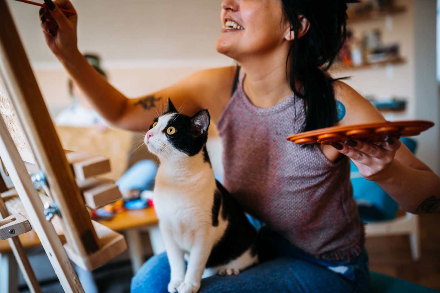Resident working with their cat on their lap at M2 Apartments in Denver, Colorado