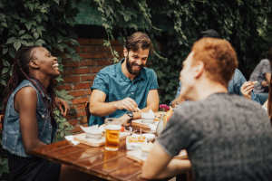 Couple of friends having food at Oak Manor Apartments in Henderson, Texas