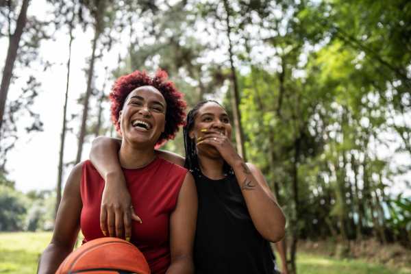 Two women laughing with a basketball near Dakota at Hillcroft in Houston, Texas