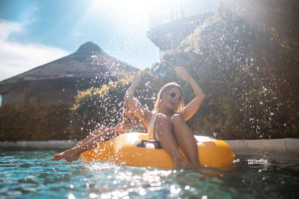 Residents on a yellow float in water at Dakota at Hillcroft in Houston, Texas