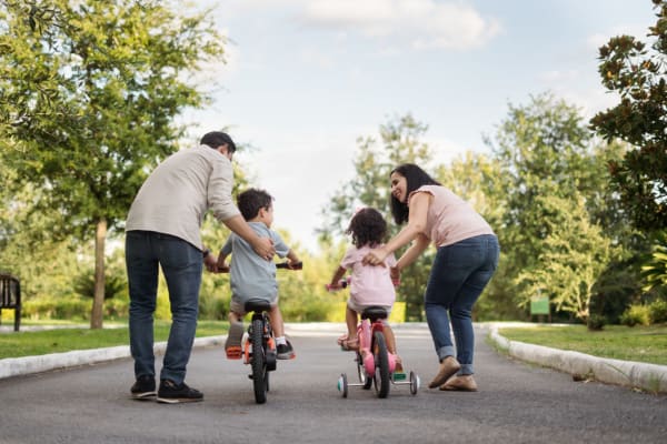 Residents teaching their kids how to bike near The Palms Apartments in Sacramento, California