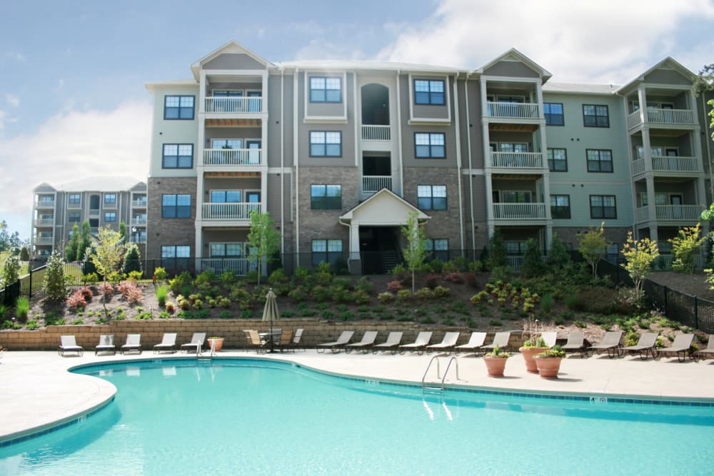 Mature trees and chaise lounge chairs around the swimming pool at Cahaba Grandview in Birmingham, Alabama