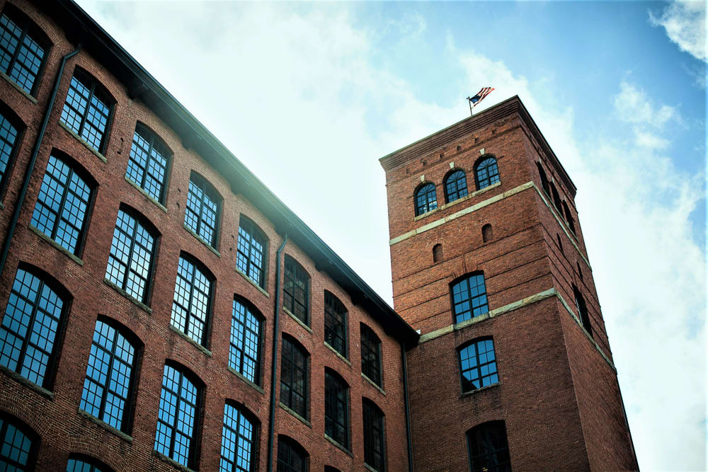 Spacious living room with large windows at Loray Mill Lofts in Gastonia, North Carolina