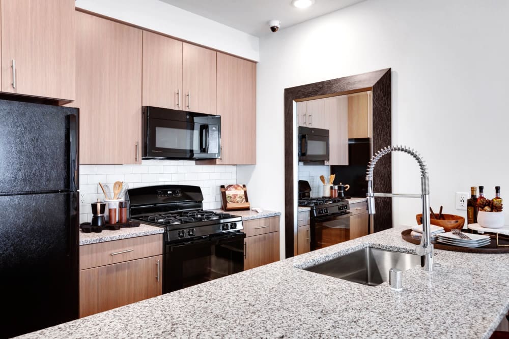 Modern kitchen with granite countertops at Olympus Highlands North in Albuquerque, New Mexico