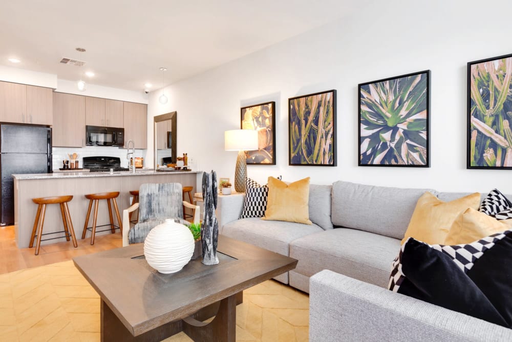 Model living room and kitchen with bar seating at Olympus Highlands North in Albuquerque, New Mexico