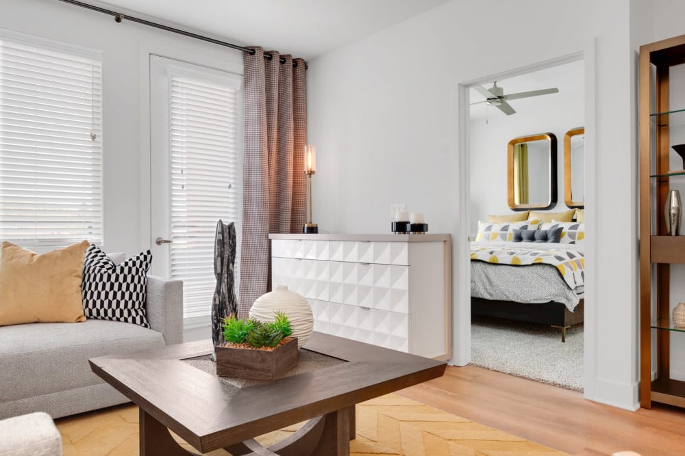 Model living room with door to balcony at Olympus Highlands North in Albuquerque, New Mexico