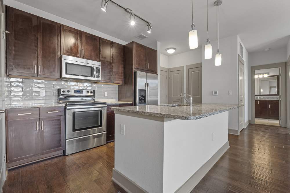 Kitchen with stainless-steel appliances at The Standard in Dallas, Texas