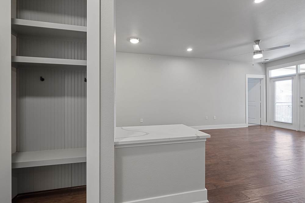 Unfurnished living room with shelves at The Standard in Dallas, Texas