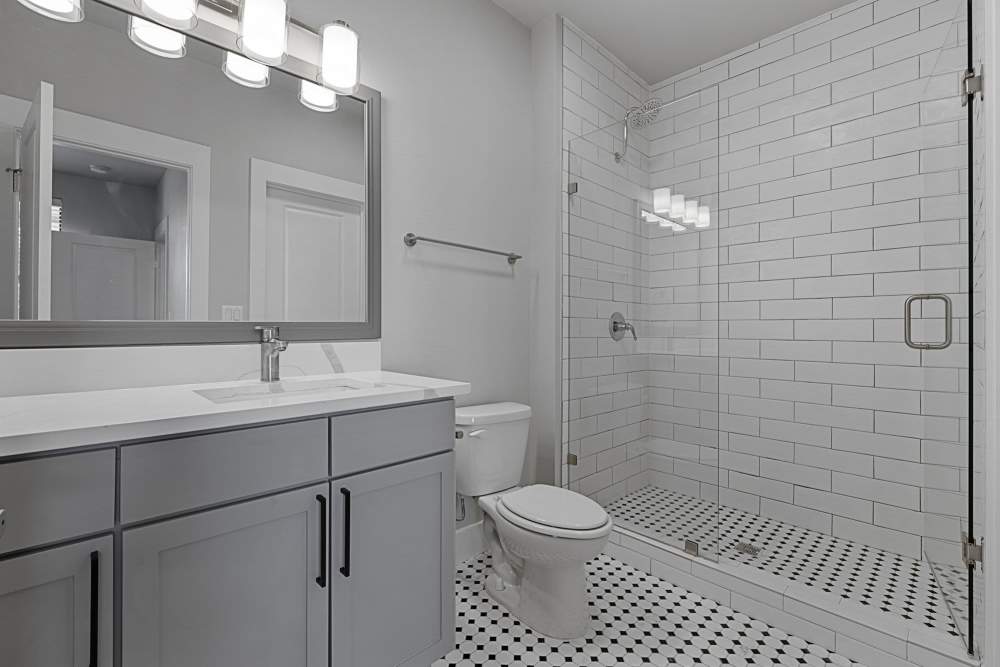 Bathroom wiith walk-in shower and large vanity at The Standard in Dallas, Texas