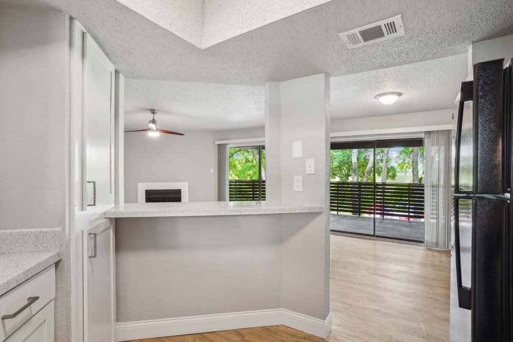 Kitchen with island and connecting living area at Vantage Point Apartments in Dallas, Texas