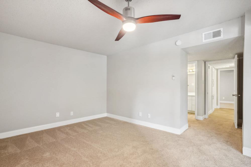 Bedroom with connecting rooms and ceiling fan at Vantage Point Apartments in Dallas, Texas