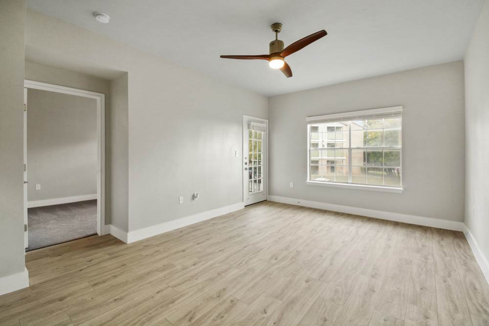 Unfurnished living room with window and ceiling fan at Cayman, Universal City, Texas