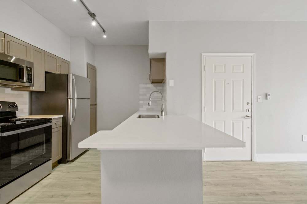 Bright kitchen with island and appliances at Cayman, Universal City, Texas