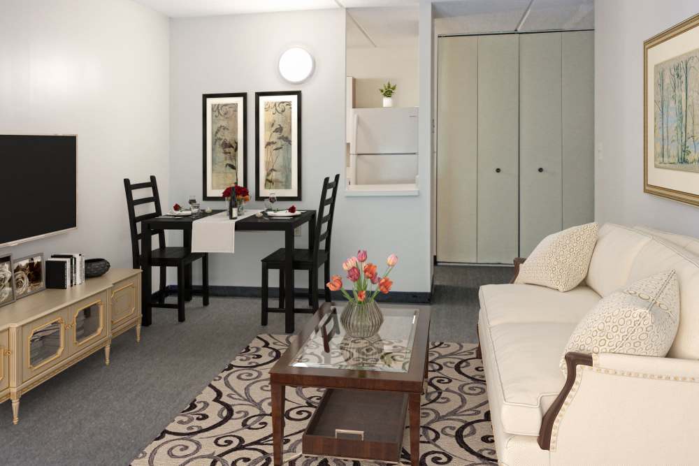 Living room with a couch and a dining area at Fairhaven Village in Fairhaven, Massachusetts