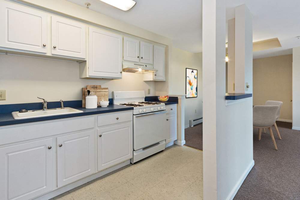 Comvenient kitchen with white cabinets at Stony Brook Village in Westford, Massachusetts
