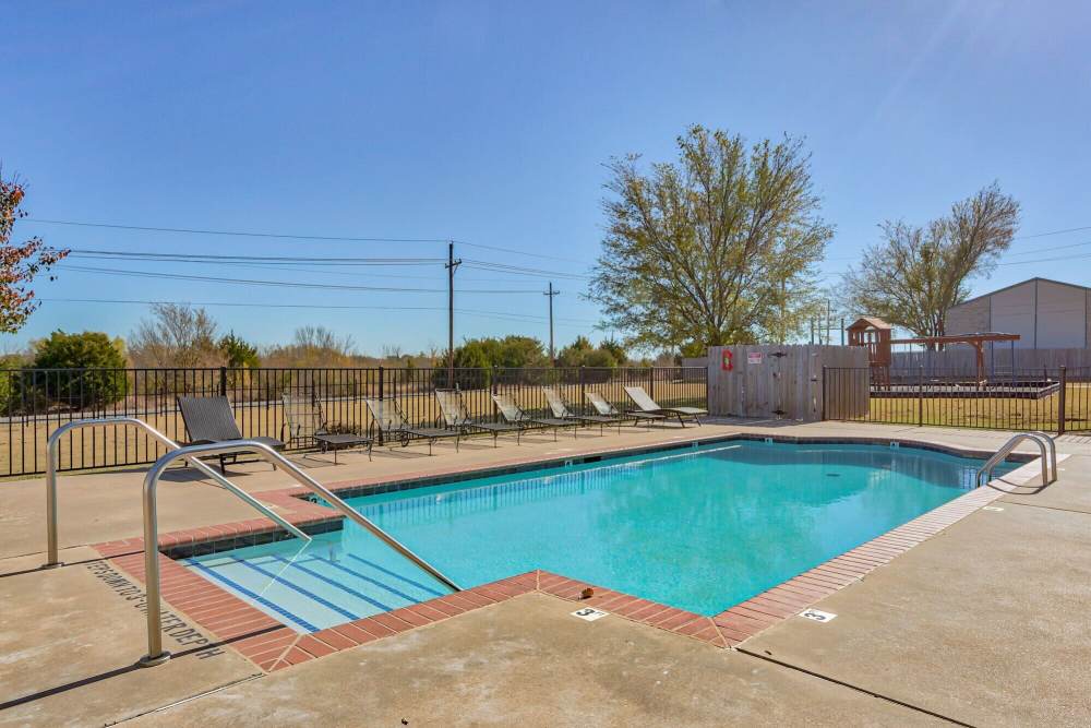 Serene swimming pool at The Gardens At Duncan Apartments in Duncan, Oklahoma