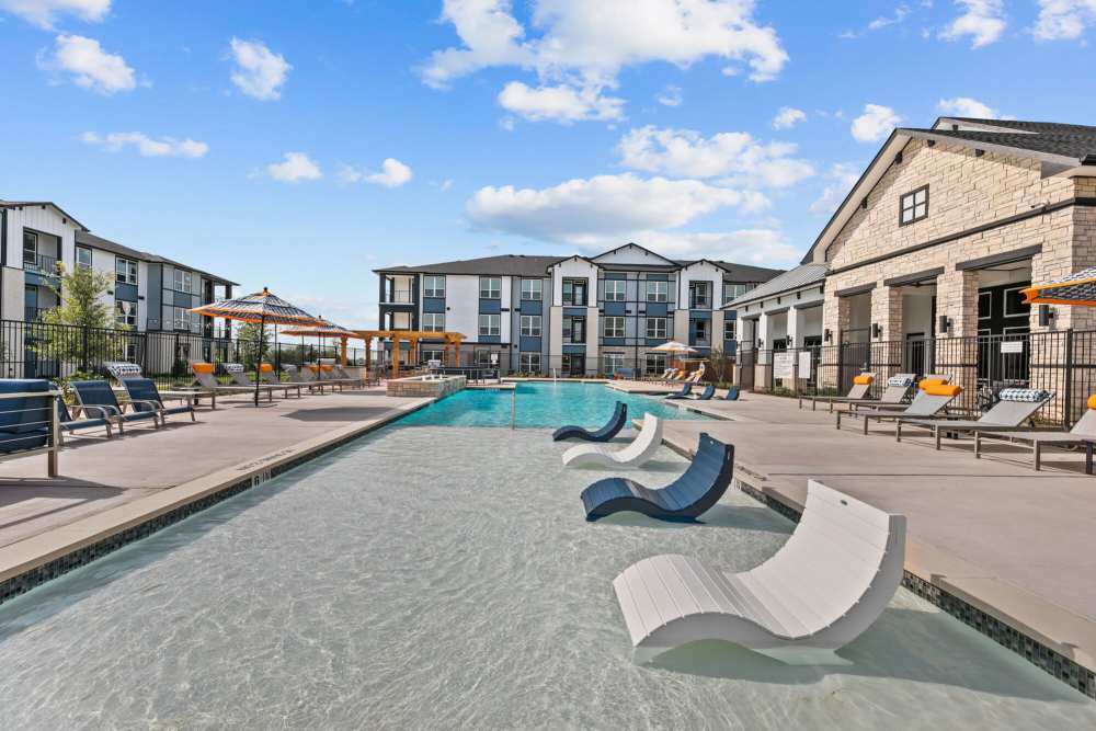 Resort-Inspired pool with sundeck and lounges at The Summit at Walnut Creek in Alvarado, Texas