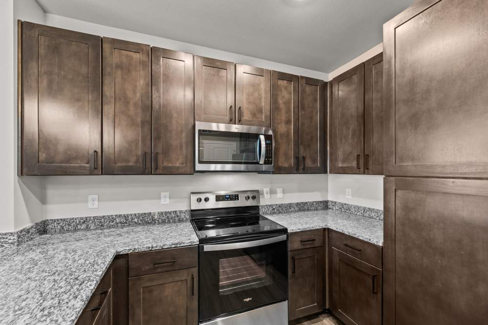 Granite counters and shaker style cabinetry at The Summit at Walnut Creek in Alvarado, Texas