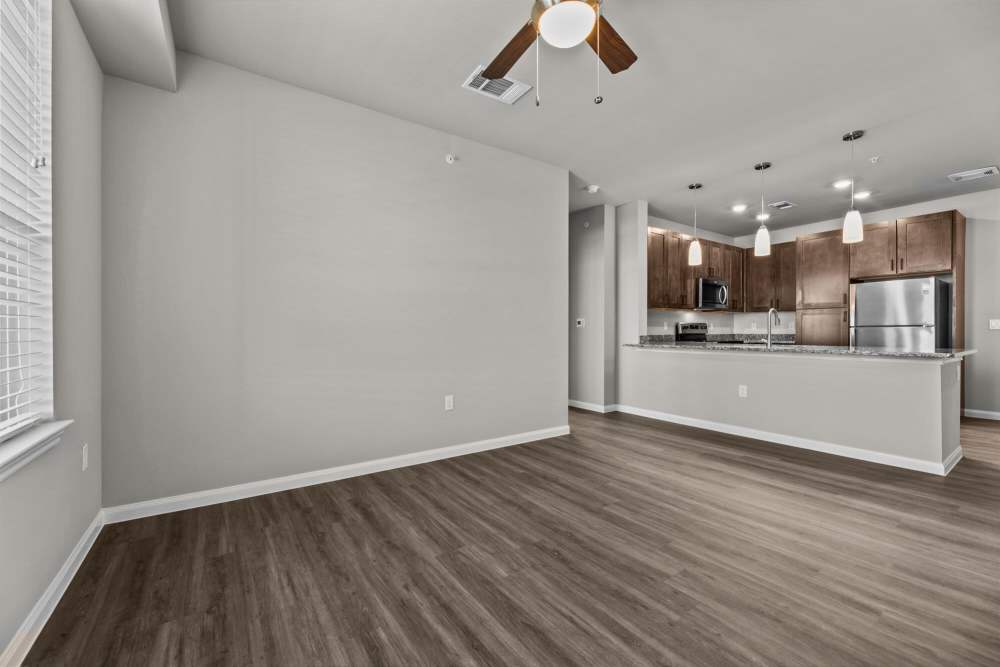 Wood-style floored apartment with open kitchen at The Summit at Walnut Creek in Alvarado, Texas