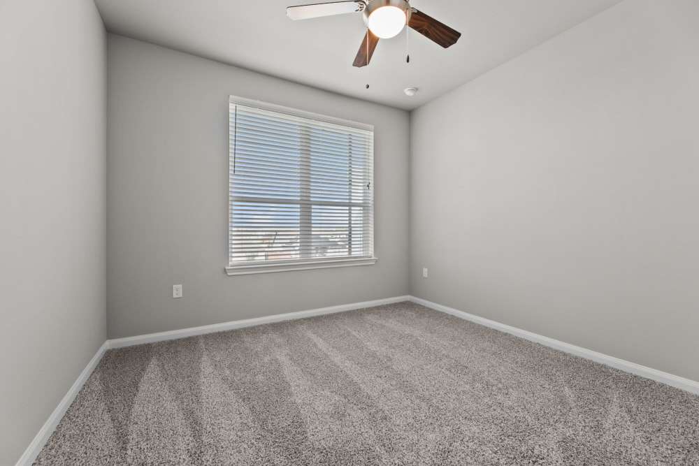 Carpet flooring and ceiling fan in bedroom at The Summit at Walnut Creek in Alvarado, Texas