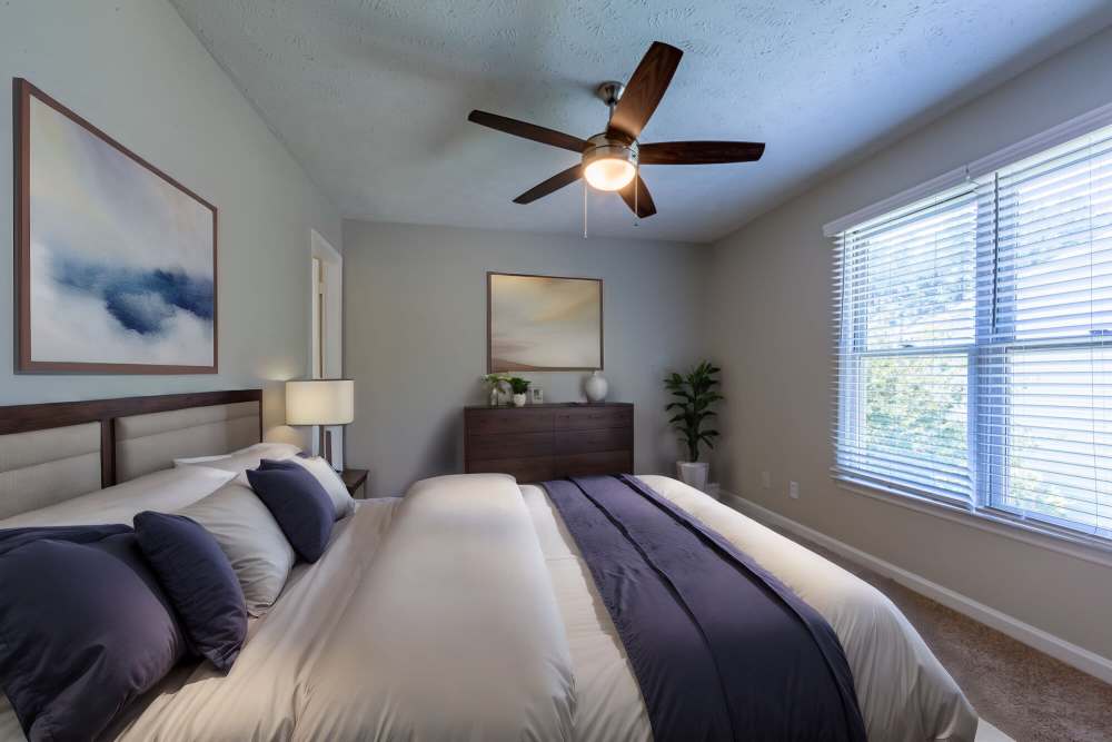 Bedroom with large comfortable bed at Cape Fear Townhomes in Fayetteville, North Carolina