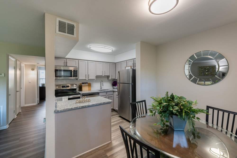Dining area with kitchen view at Woodmere Trace in Norfolk, Virginia