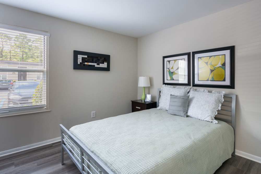 Bedroom with wood-style flooring at Woodmere Trace in Norfolk, Virginia