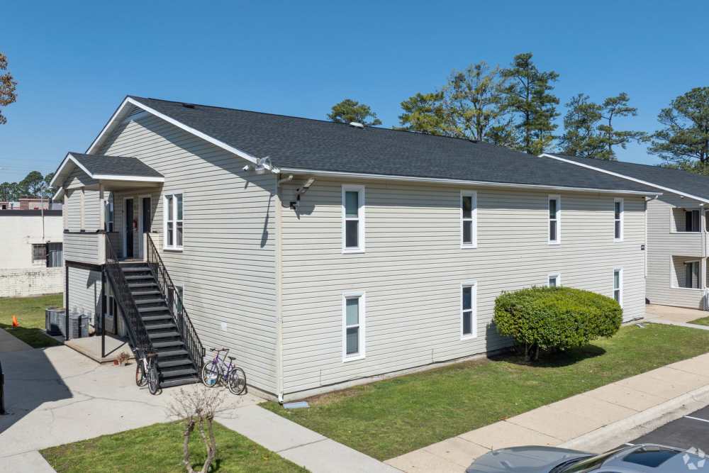 Apartment view with walking path at Ramsey Pines in Fayetteville, North Carolina