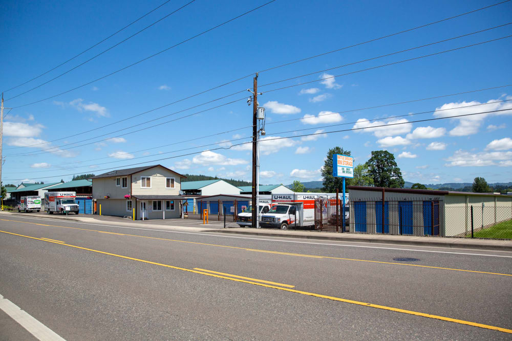 A view across the street of Battle Ground Mini Storage in Battle Ground, Washington with U-Haul trucks parked ready for pickup
