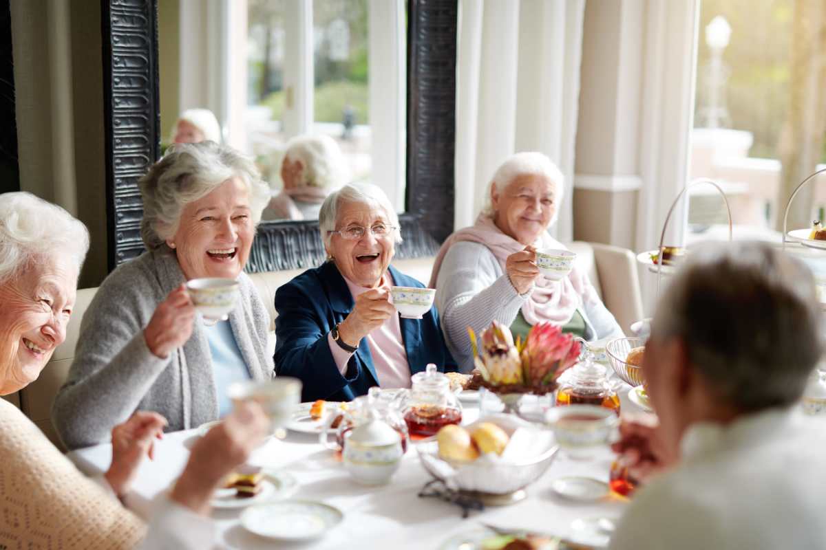 Active senior residents socializing in a restaurant near Watermere on Oak Street in Roanoke, Texas.