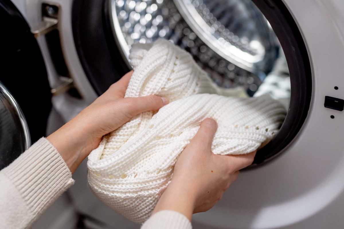 Resident taking out laundry from the dryer at Waveland Commons in Waveland, Mississippi