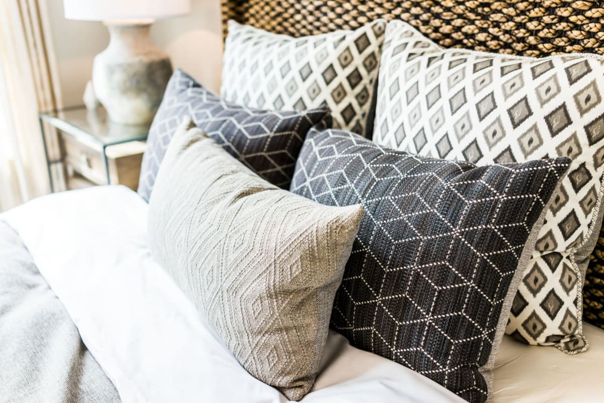 A comfy bed with soft pillows in an apartment at The Howard, Glendale, California