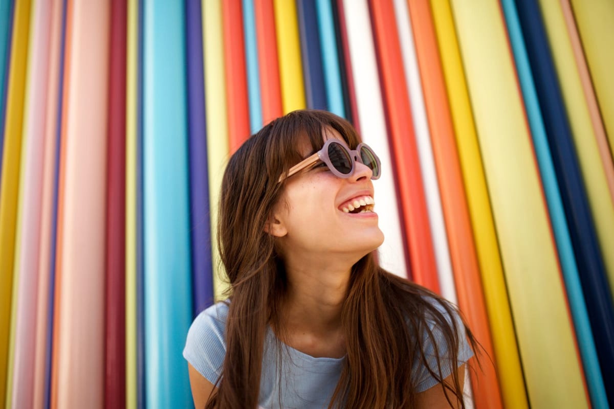 A resident stands in front of a colorful backdrop near Playa Marina, Los Angeles, California