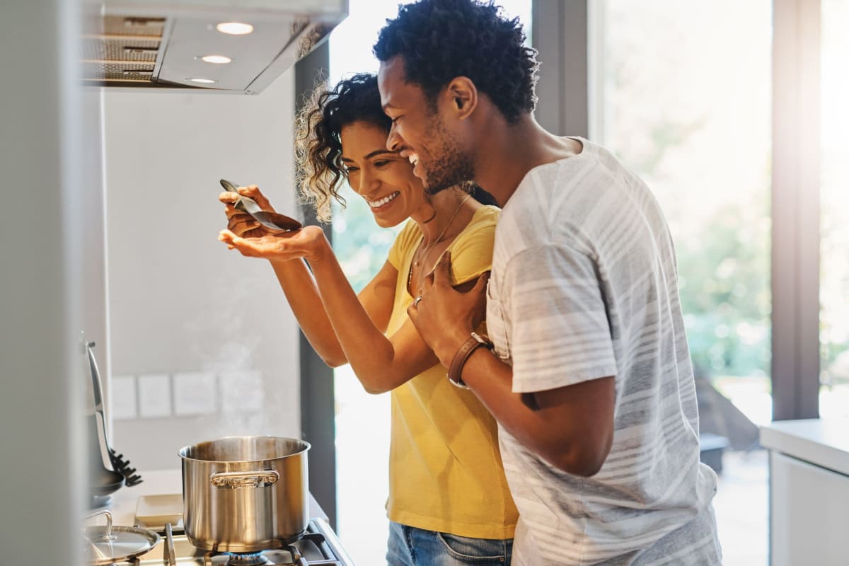 A couple prepares a meal in their kitchen at Bay on 6th, Santa Monica, California