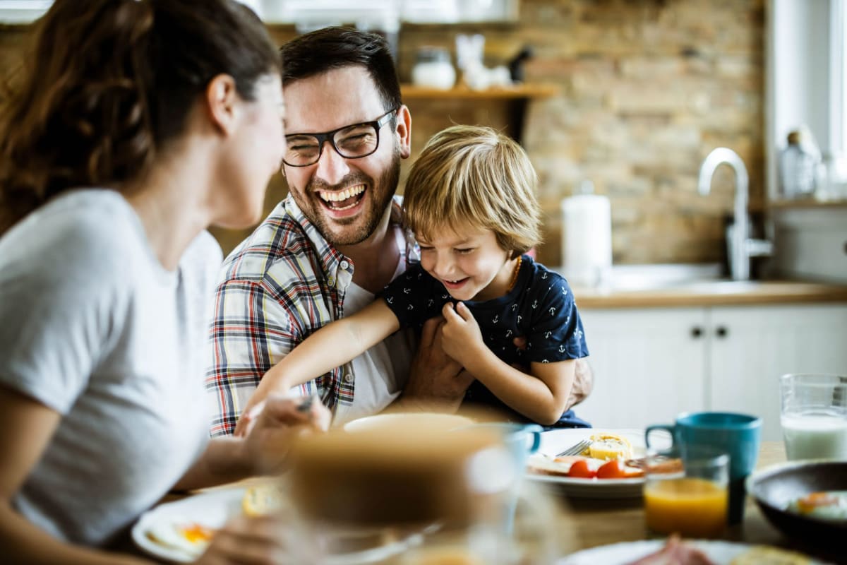 A family enjoys a meal in their kitchen at Bay on 6th, Santa Monica, California