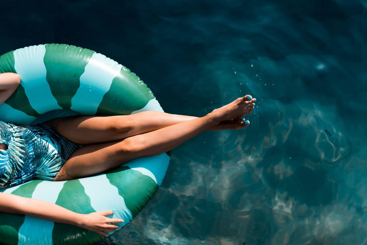 A resident on a floatie in the pool at Bay on 6th, Santa Monica, California