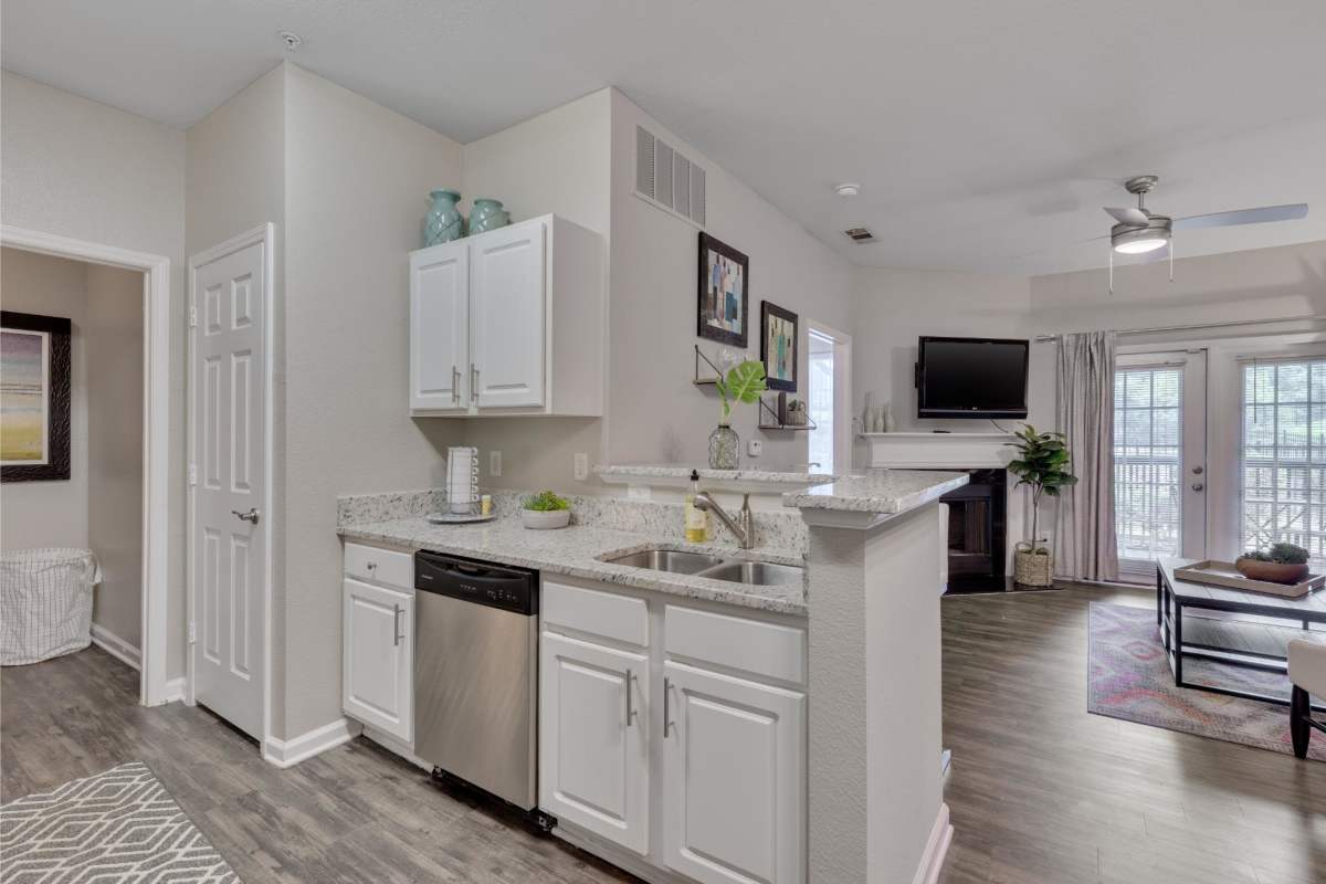 Open-concept of kitchen and living room at Weston Reserve Apartments in Morrisville, North Carolina