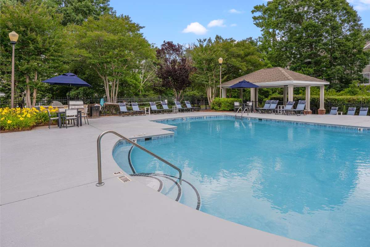 Swimming pool with lounge chairs at Weston Reserve Apartments, Morrisville, North Carolina