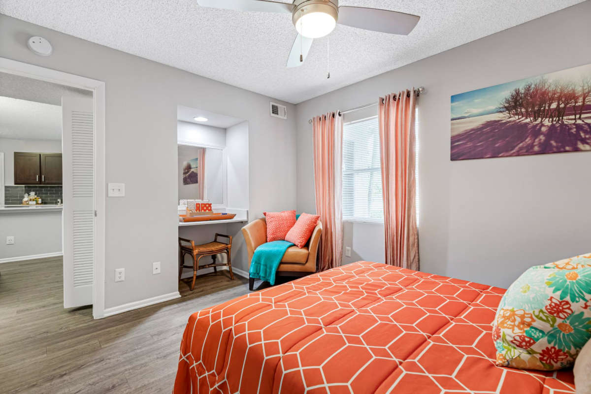 Bedroom with a large bed and ceiling fan at Centro at Davie Apartments, Davie, Florida
