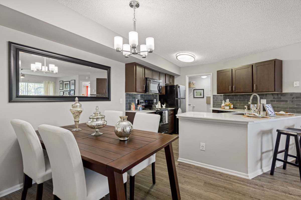 View of kitchen and dining area at Centro at Davie Apartments, Davie, Florida
