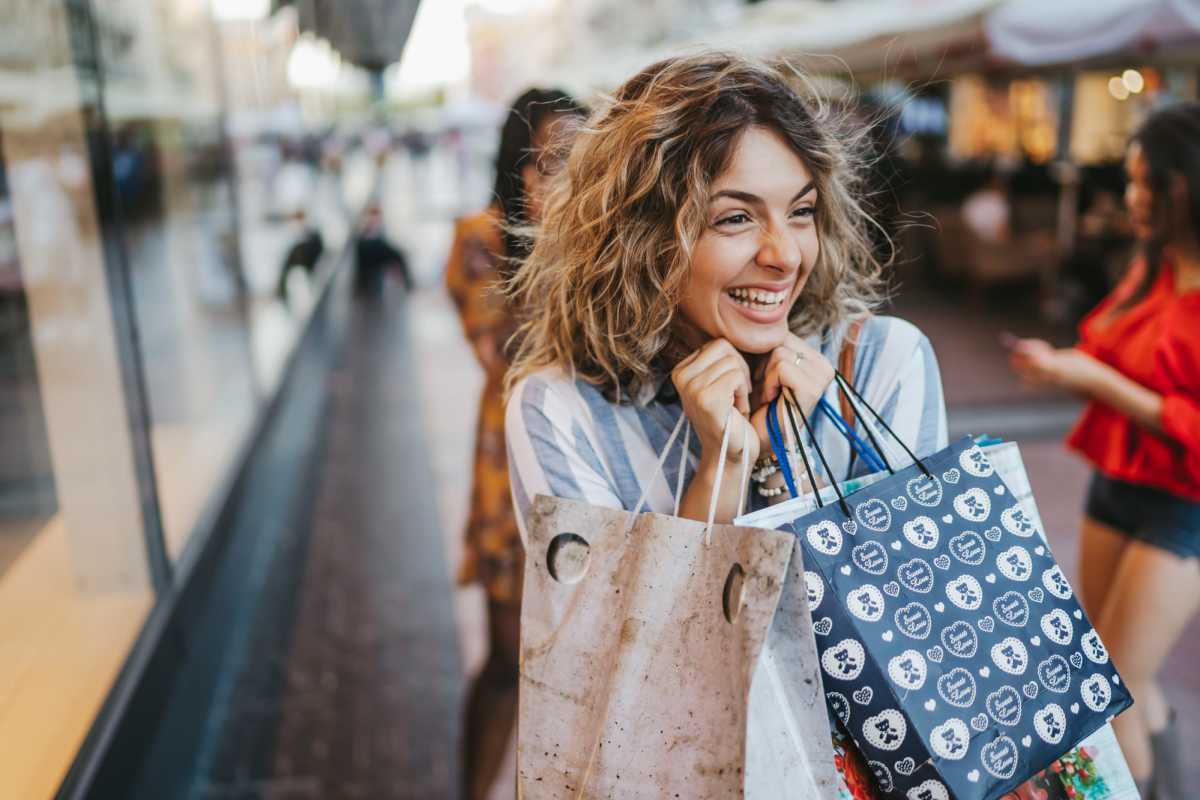Resident with shopping bags near Millpoint Townhomes in Henderson, Texas