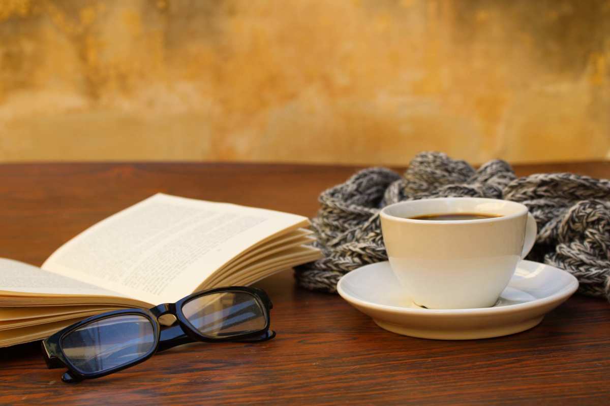 Coffee cup by book, glasses, blanket on table at Harvest Hill in Broomfield, Colorado