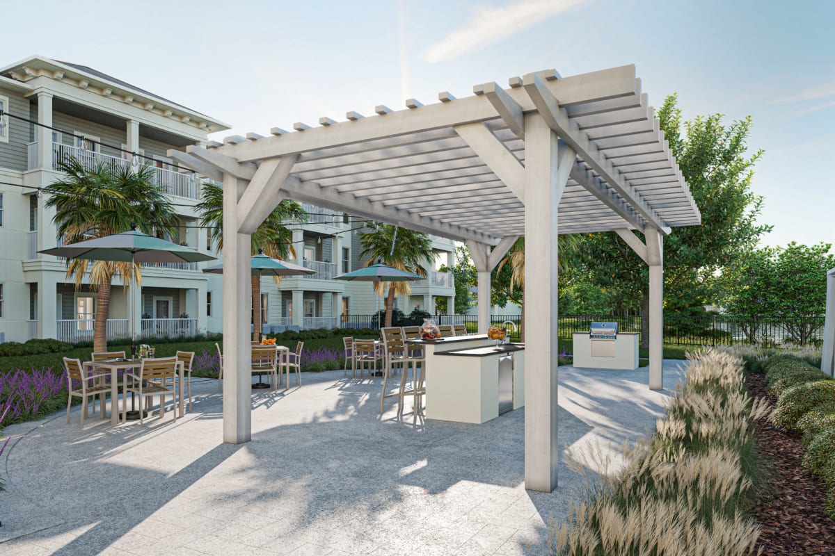Cover patio with outdoor grilling kitchen and fire pits at The Griffon Vero Beach in Vero Beach, Florida