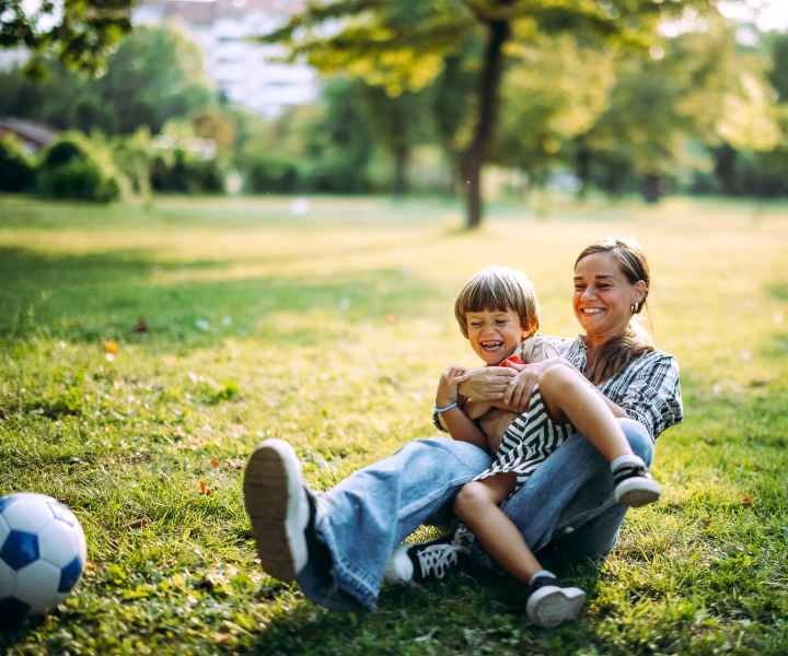 Resident playing in the park with her kid near El Jardin Apartments in Hollywood, Florida