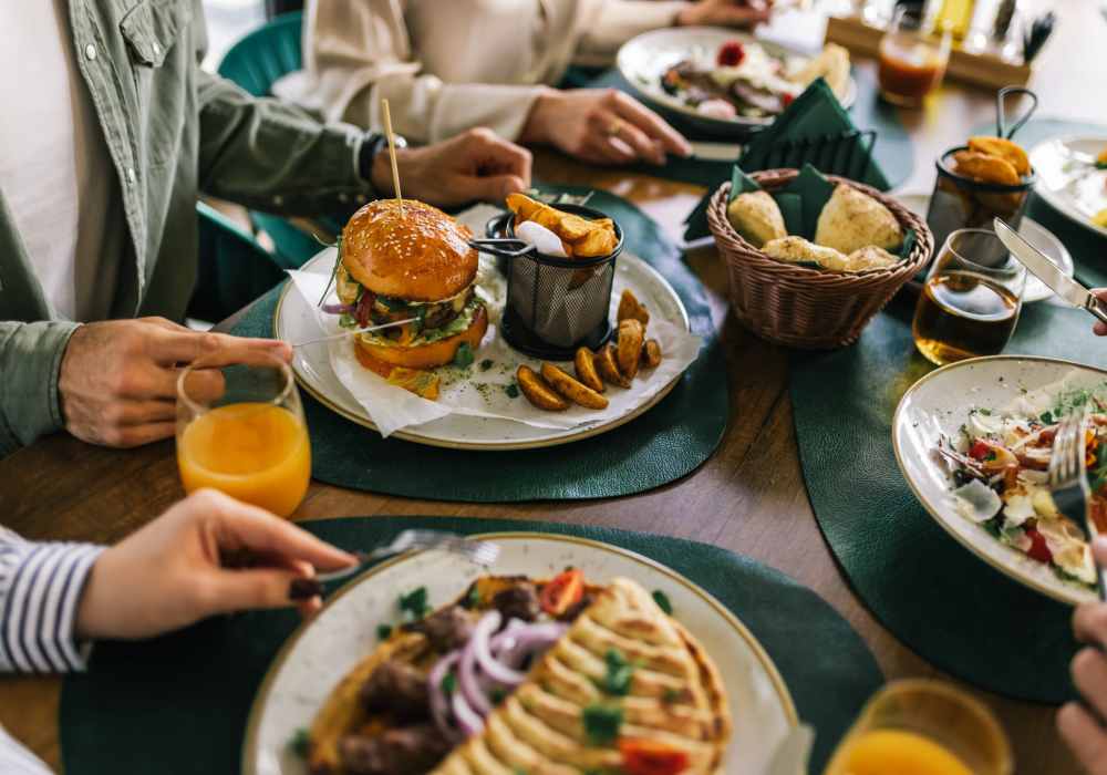 Dining table with burgers and salads at Balcones Trails in Kyle, Texas