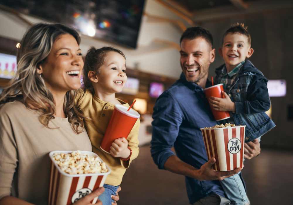 Residents holding popcorn inside a movie theater near Unionville Station Townhomes in Hilton, New York