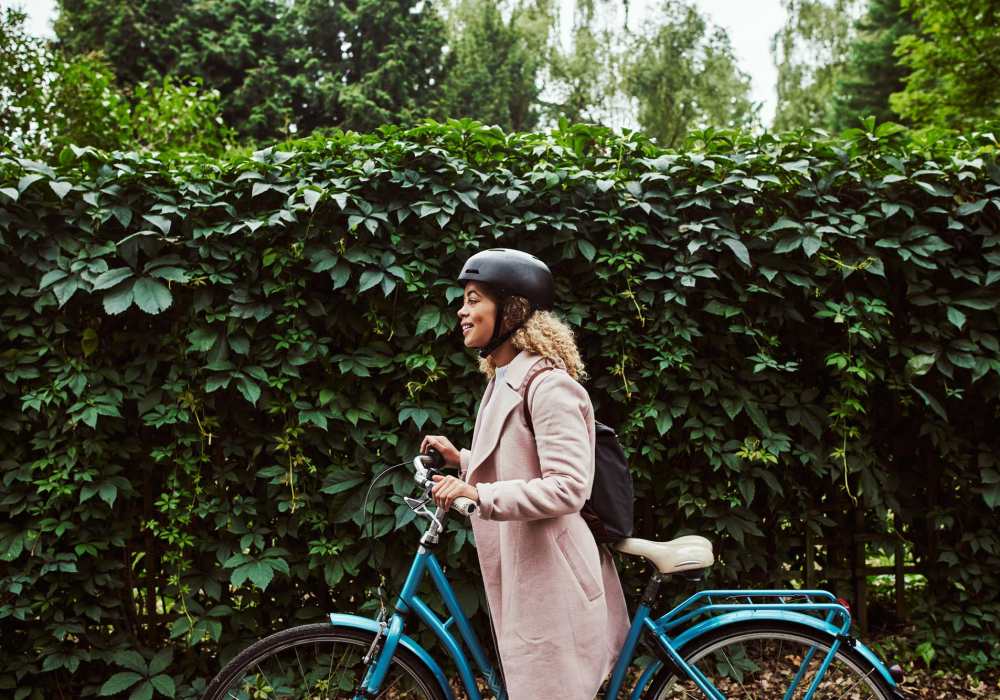 Resident woman with a bicycle down the street at Bridges at San Ramon in San Ramon, California,