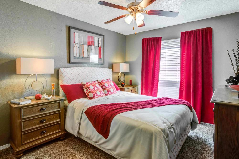 Brightly decorated model bedroom at Sausalito Apartments in College Station, Texas